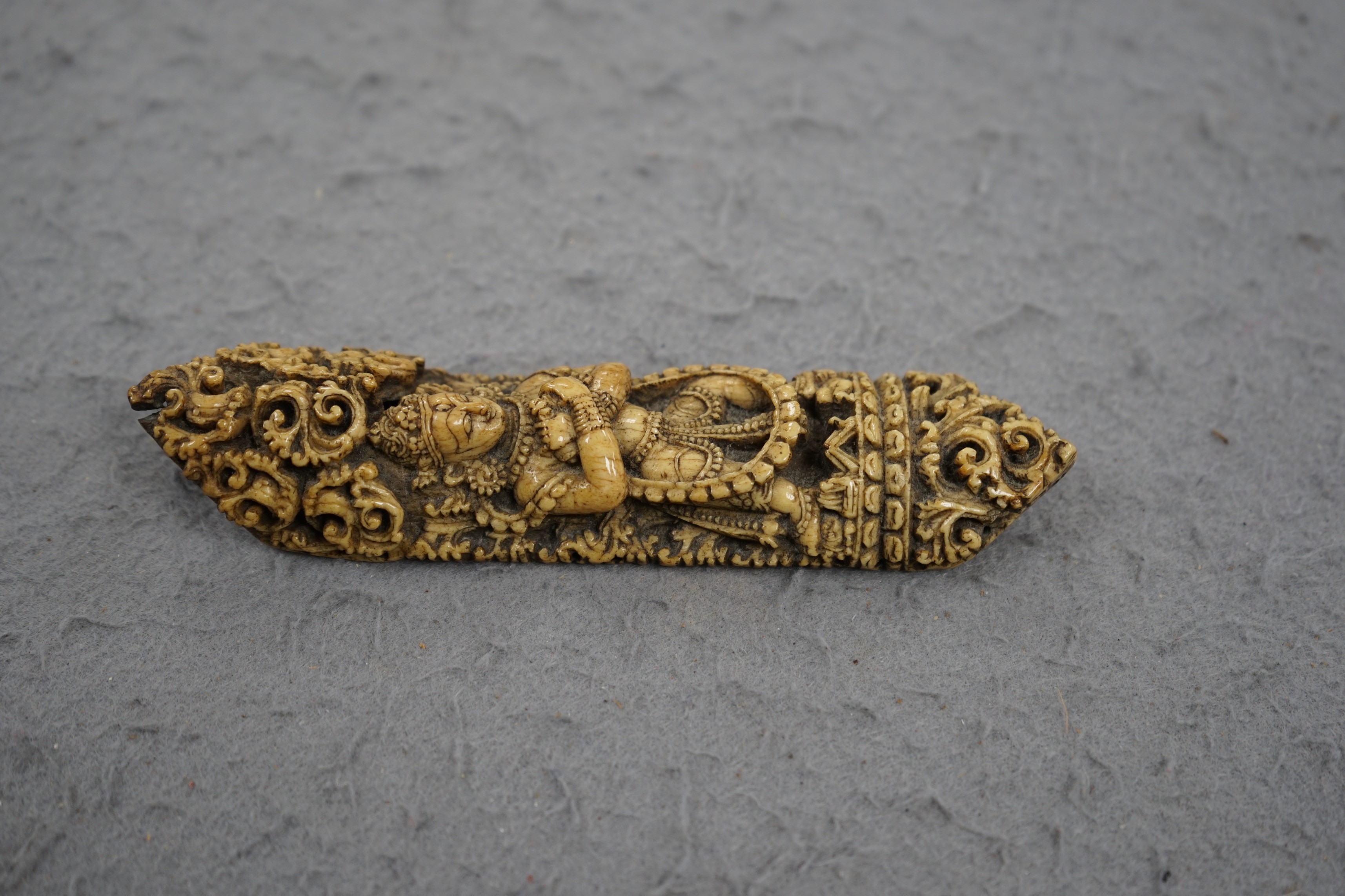 A 19th century Burmese bone carving of a Buddhist deity, 15cm tall